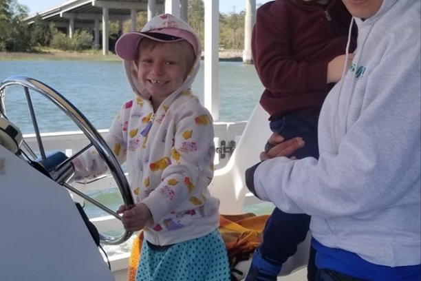 Mom and Kids steering a dolphin boat in Hilton Head