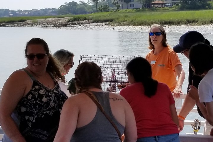 Hilton Head guide educating boat tour group on Crab and Lobster Traps
